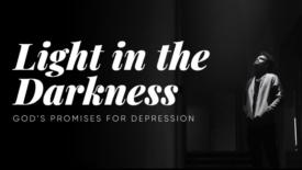 A person stands alone in a dark hallway, looking upward toward a beam of light shining down on them. Text on the image reads: ‘Light in the Darkness’ and ‘God’s Promises for Depression.’